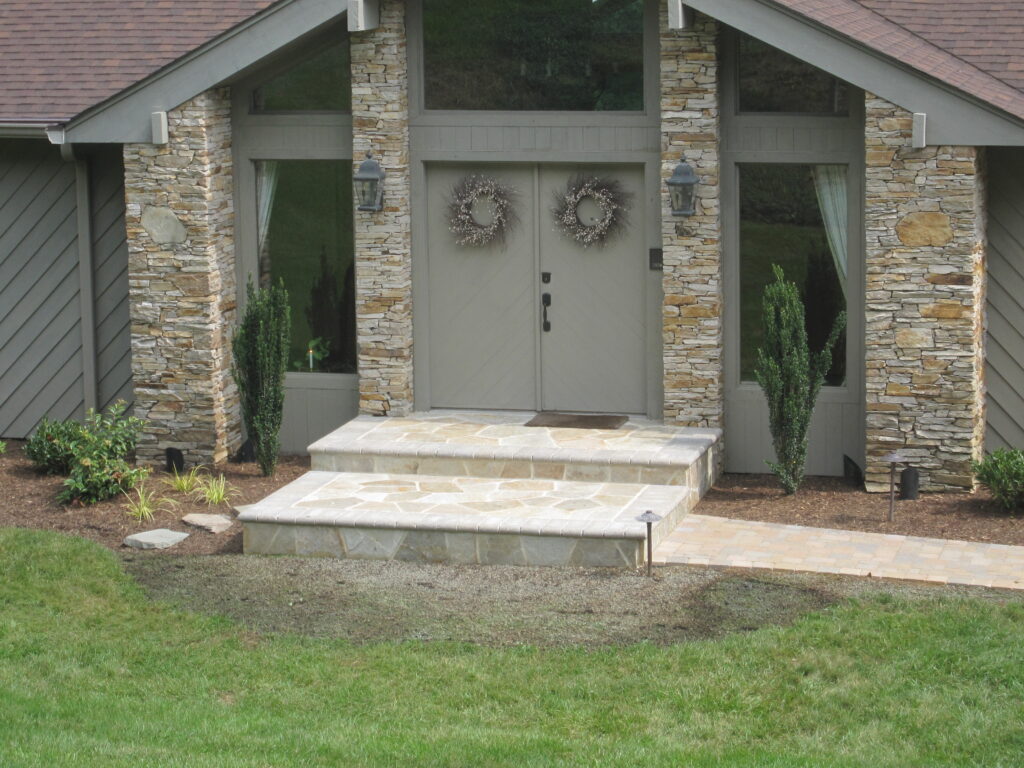 FRONT DOOR - Veneer Maryland wallstone house columns and landing,  Paver walkway,  Cast pathway lighting