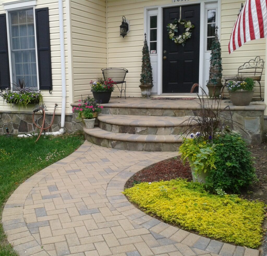 FRONT ENTRANCE - Natural stone veneer on steps, Brick paver walkway and Natural stone veneer on house. 